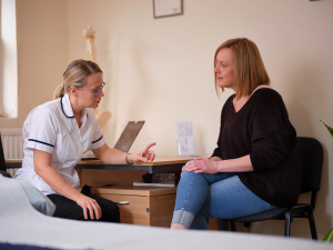 Sheena consulting with a patient