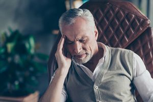 Man with headache and neck pain